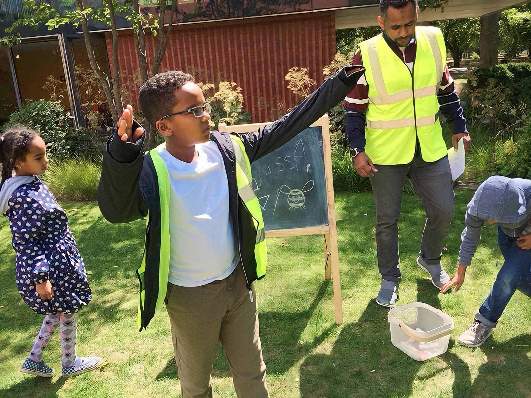 Children outdoors with a volunteer during a visit